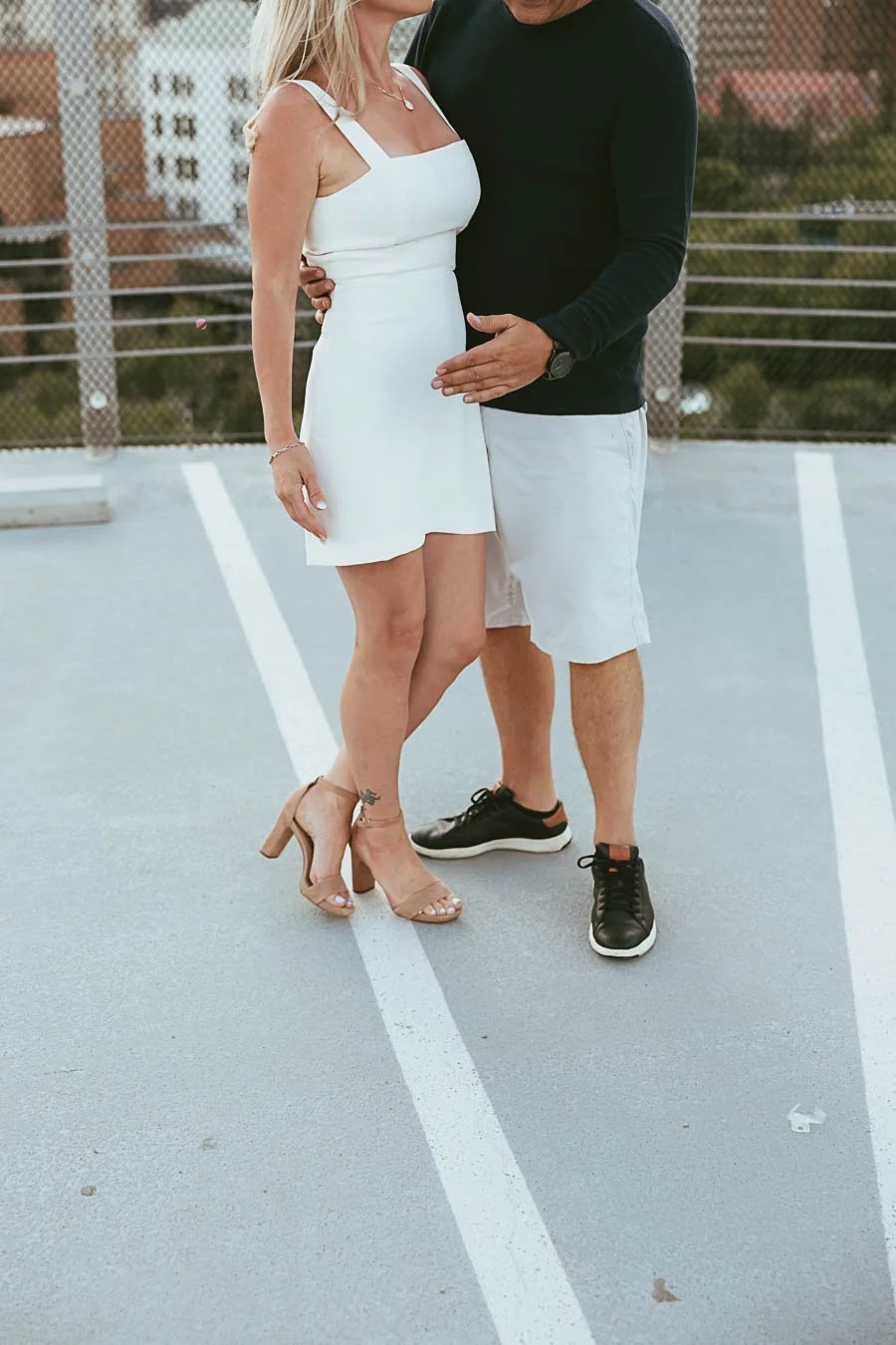Urban engagement session in Calgary Alberta with city skyline, modern architecture, and couple walking through downtown streets