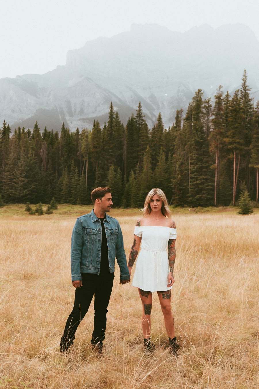 Couple embracing during a mountain engagement session in Banff, Alberta.