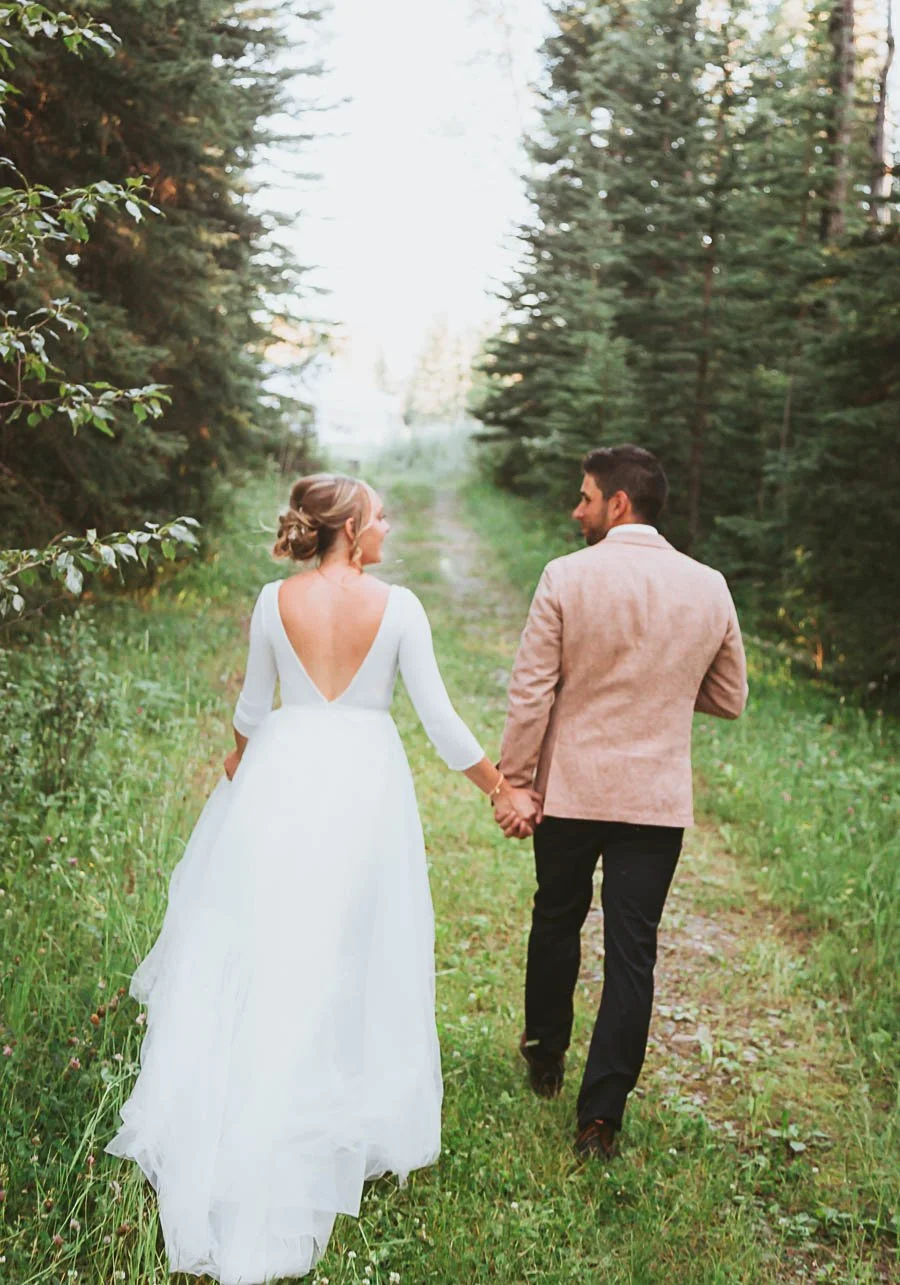 “Rustic wedding couple celebrating in Cremona Alberta with prairie landscape, golden light, and natural outdoor country setting”
