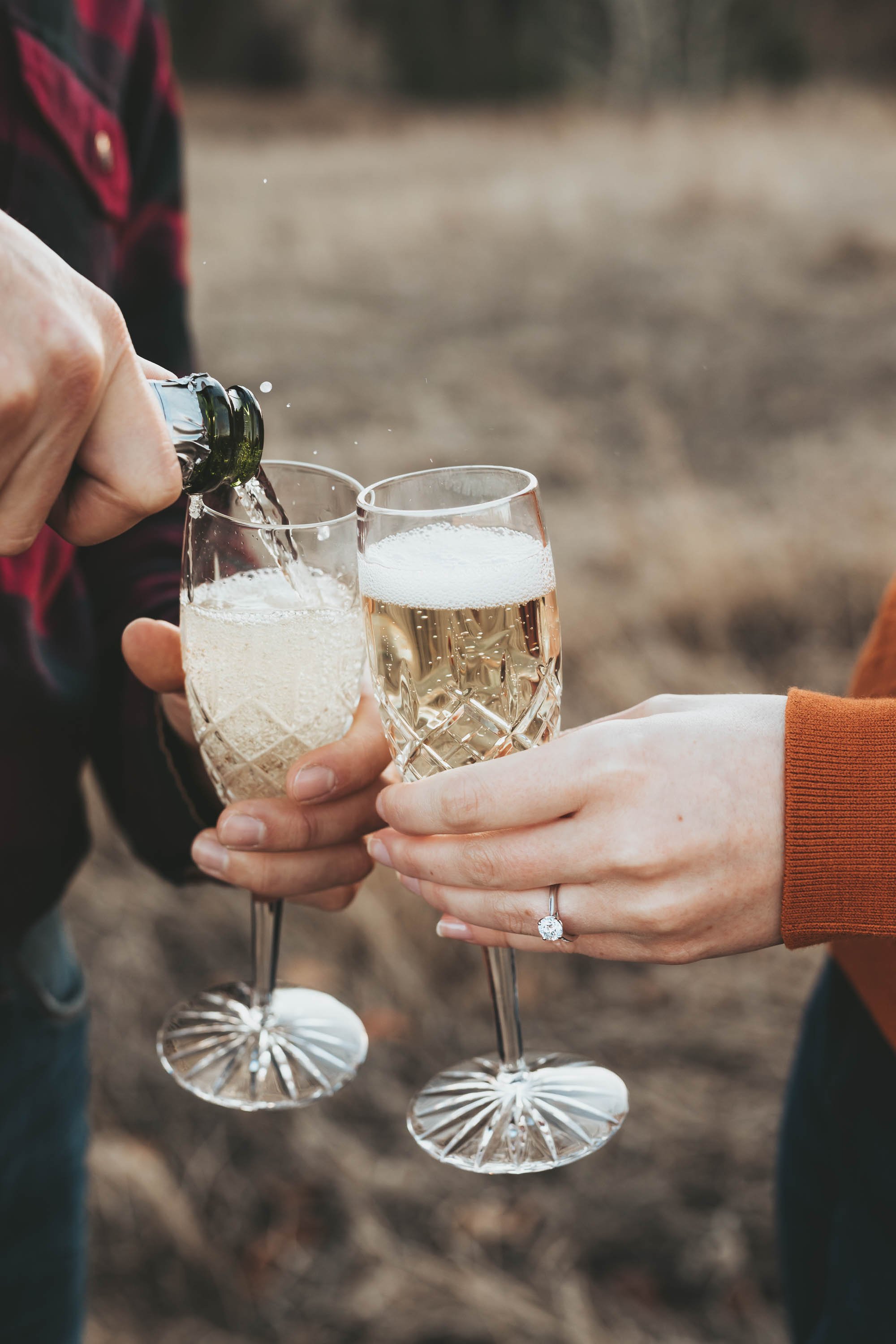 Champagne pop for a romantic engagement portraits at golden hour in the Alberta parks
