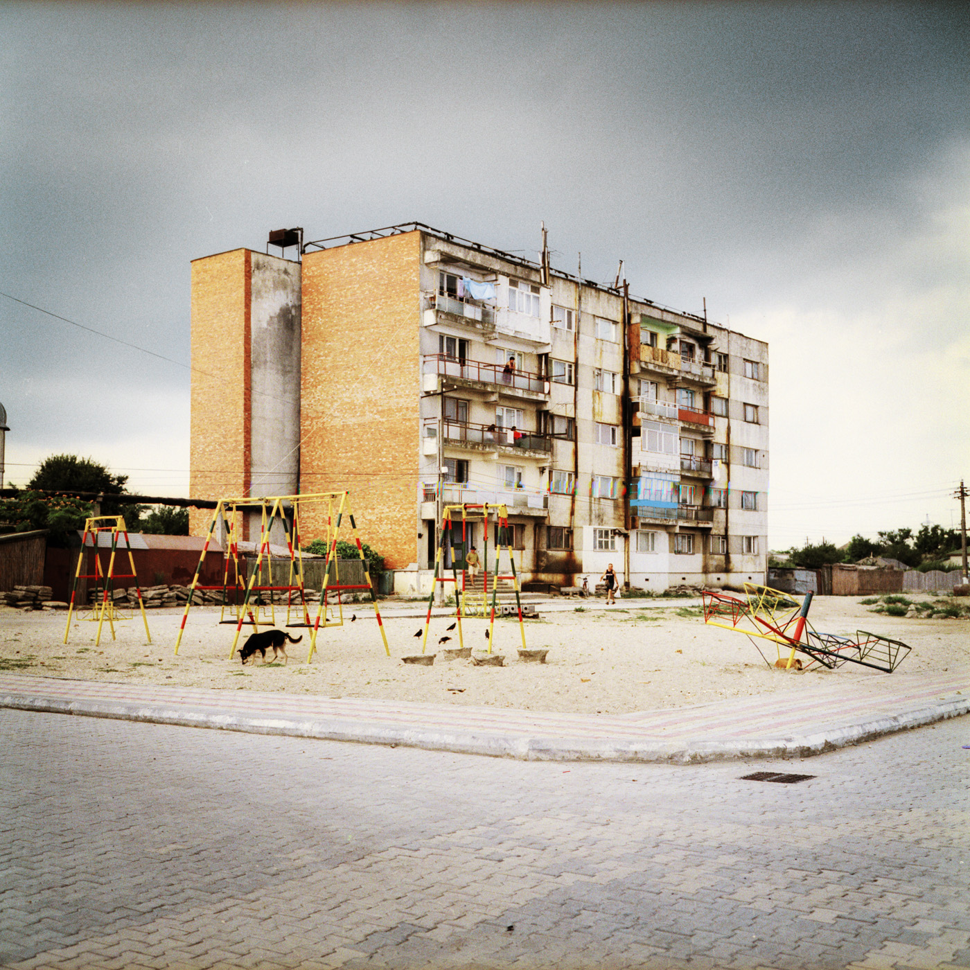  In Sulina, typical communist building stand along with traditional little houses 