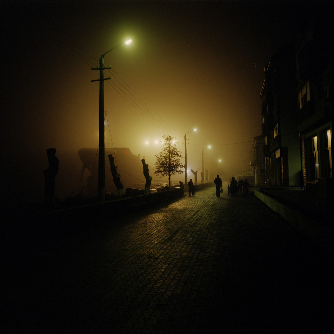  On the early evening, the boats are waiting for the sun to come up and the fog to go away to take the sea. 