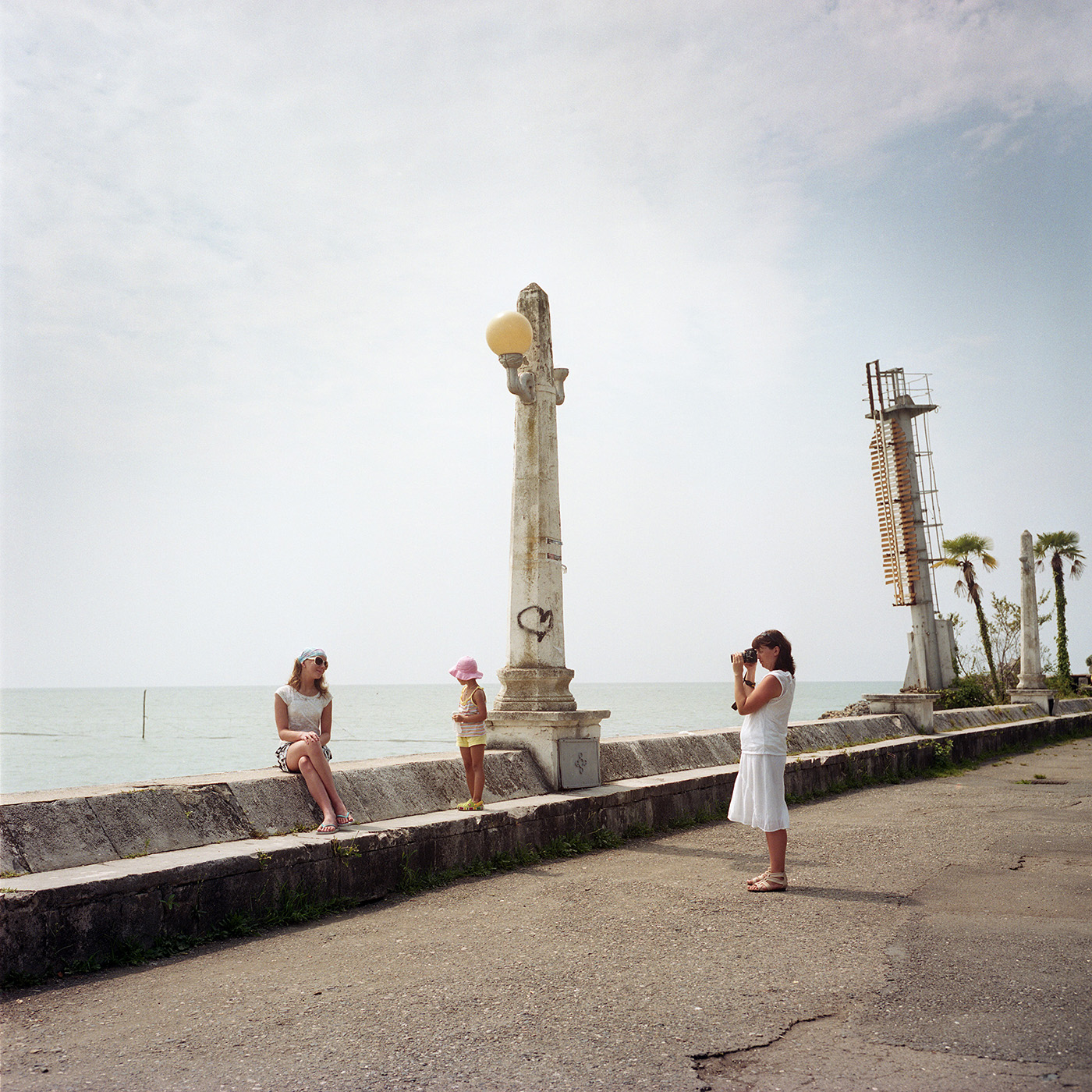  Tourists take photos in Sukhum(i) along the seaside. 