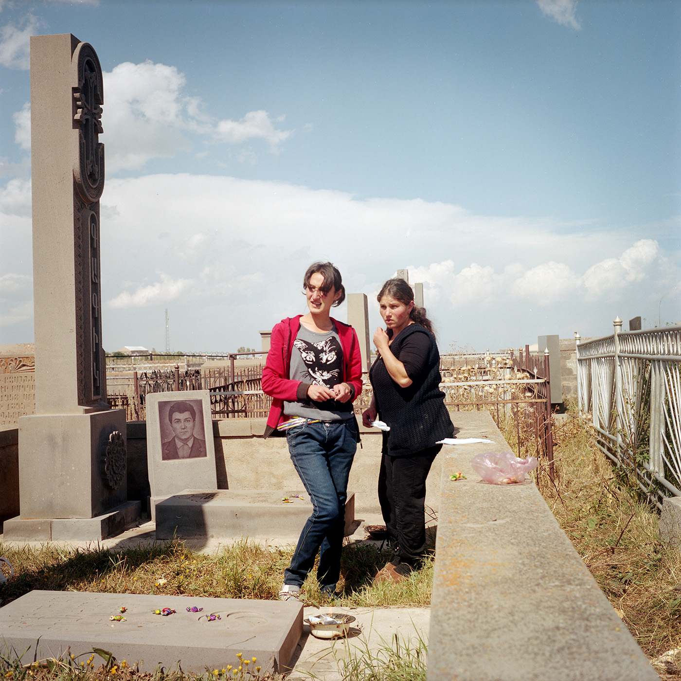  Today is the feast of the dead, the villagers go to the cemetery. They burn incense on the graves and will leave candy as offering. Ana (left) and Elvira (right) (cousins ââby marriage) go there together. Their husbands are in Russia. 