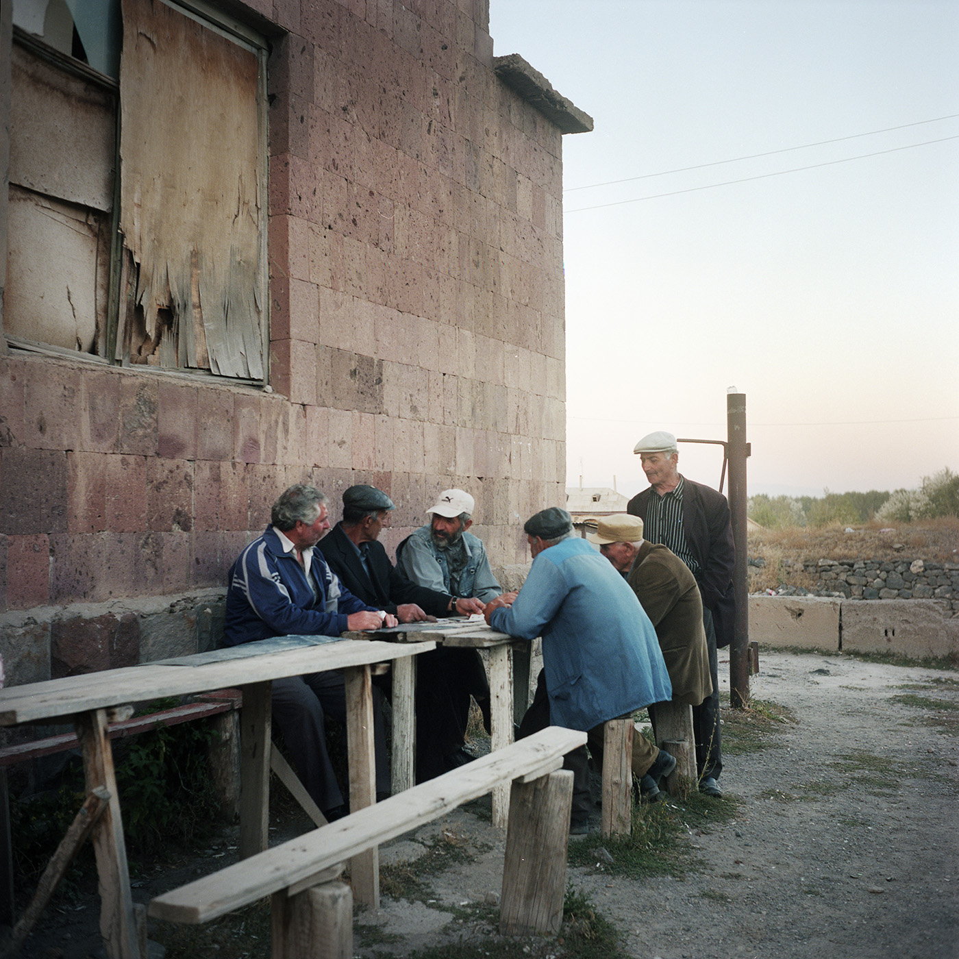  Every day they're here, it is the point of gathering for the old men of the village. They play cards, talk, play with their rosaries and tell how life has become difficult here. 