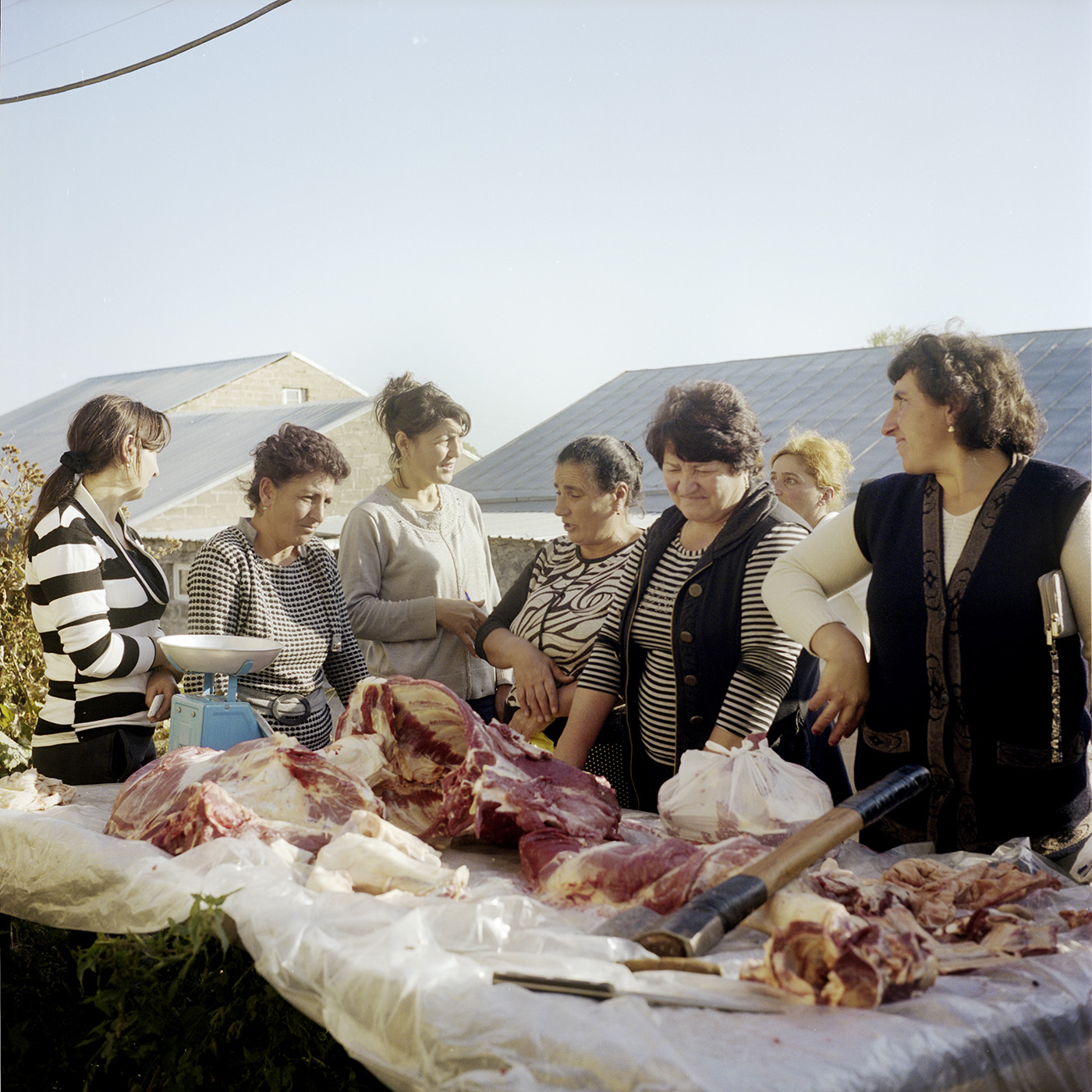  The morning. A butcher just killed two calves of a local woman, so women join to buy meat. 