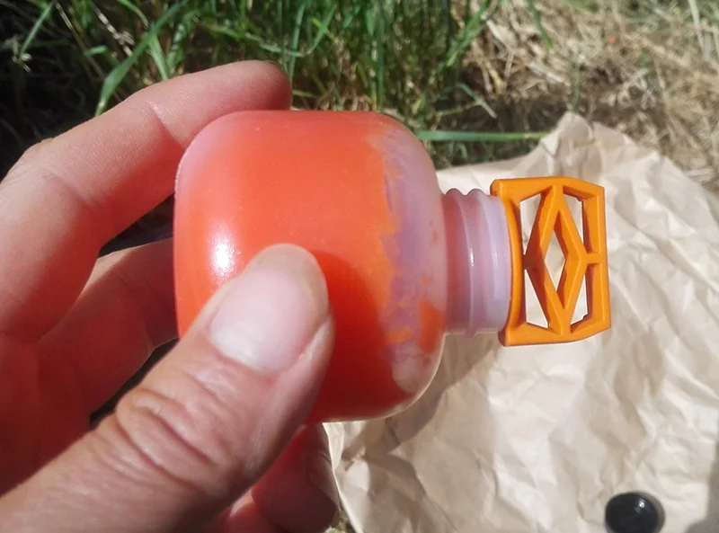 Then you either squeeze the bottle or tap the bottle against the tree to charge it, wiping off any excess (I smeared this on the tree below the trap).