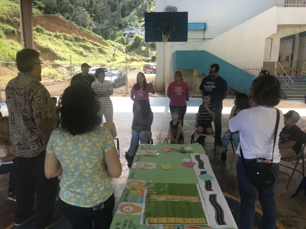 The team listens as locals tell their stories of how Hurricane Maria affected them and their neighbors.