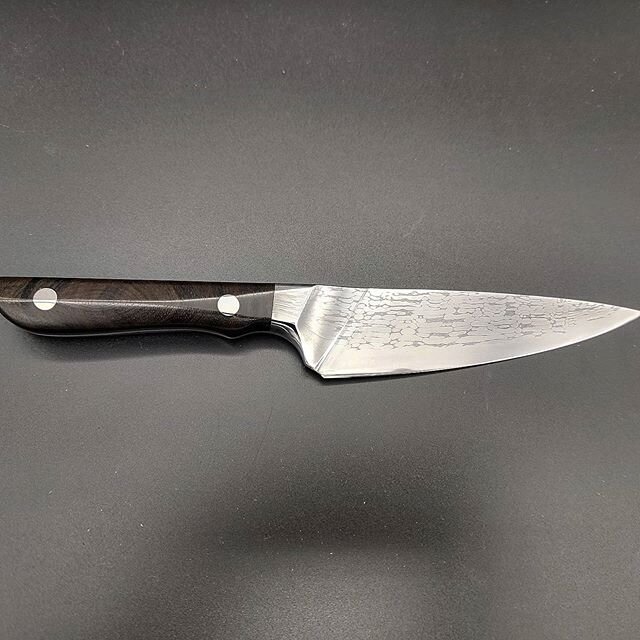 A mini chef. Fun combination of a utility and chef knife. Made of ball bearing Damascus with a 1095 edge. Rockwell C hardness of 57. The blade length is 5&quot; and the handle is made of ziricote. This is an adorable mini chef. It is currently being 