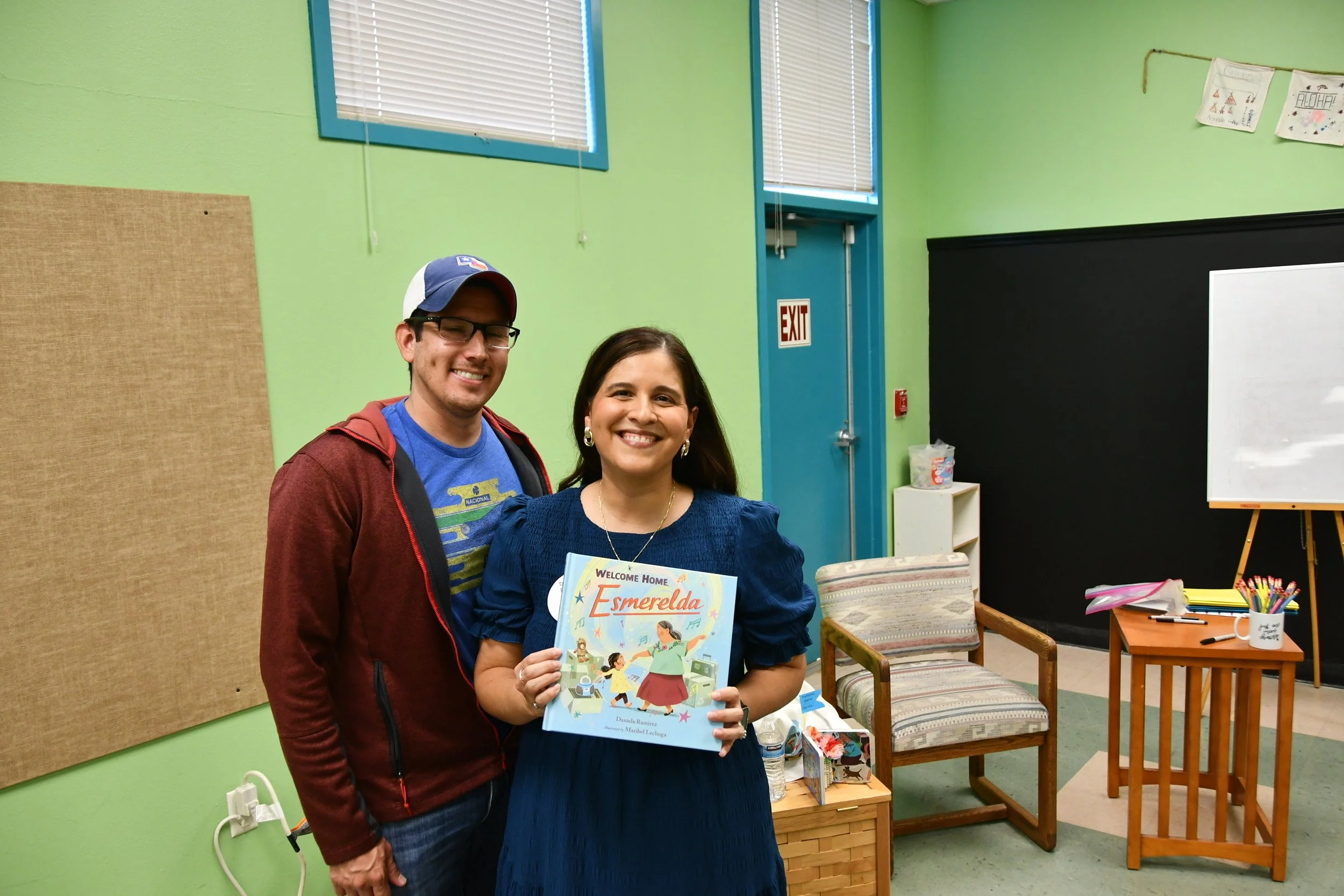 Author Daniela Ramirez and husband holding her book "Welcome Home, Esmeralda."