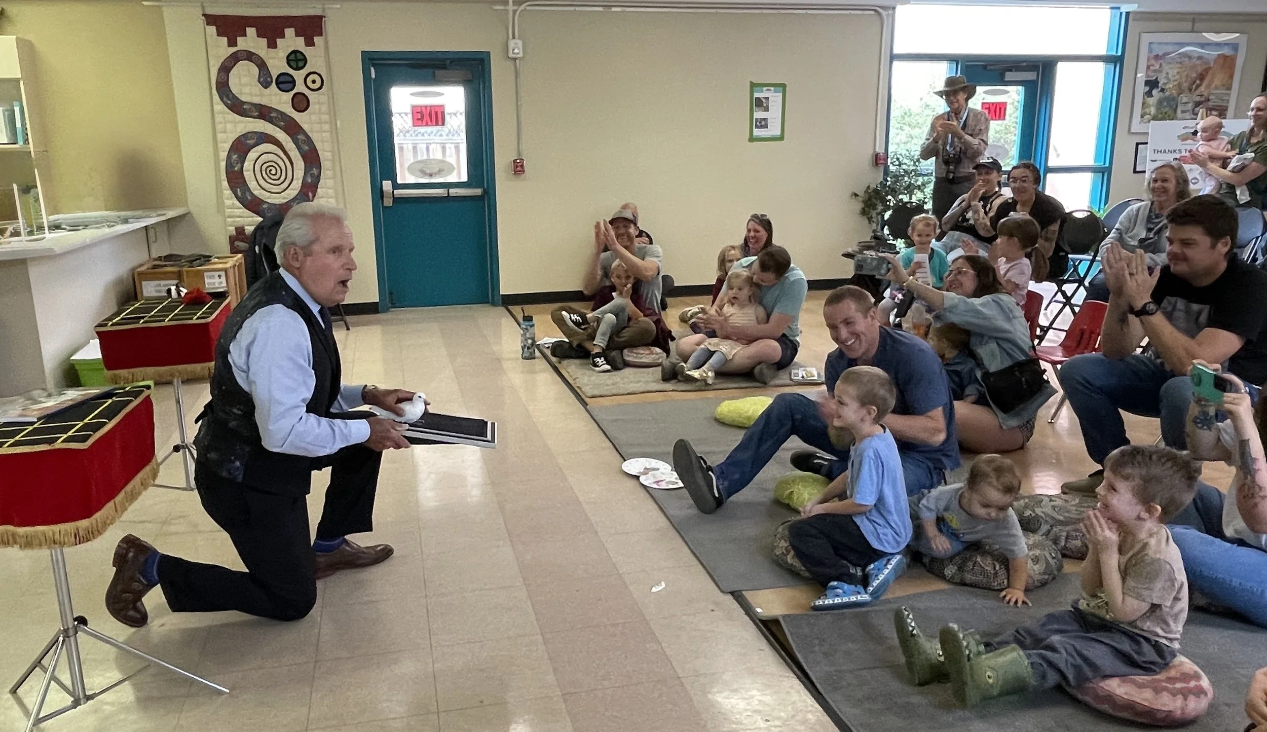 Fairgoers enjoying magician John Polinko’s presentation, a major draw to the New Mexico Children’s Book Fair.