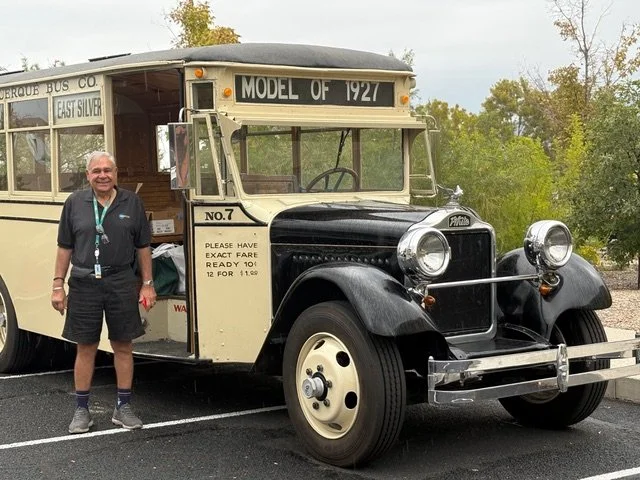 Albuquerque Transit’s Nick Manole in front of a 1927 vintage city bus full of free books for attendees at the New Mexico Children’s Book Fair.