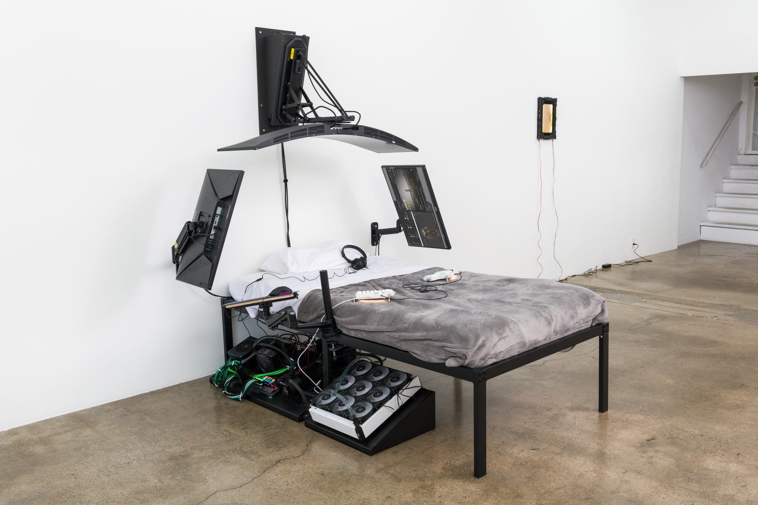  Filip Kostic,  Bed PC  (Twin), Custom built water cooled computer built into the frame of the bed. Variable screens to create a shield like shape, blanket, and pillows. Variable peripherals including keyboard, mouse, streaming microphone, and camera