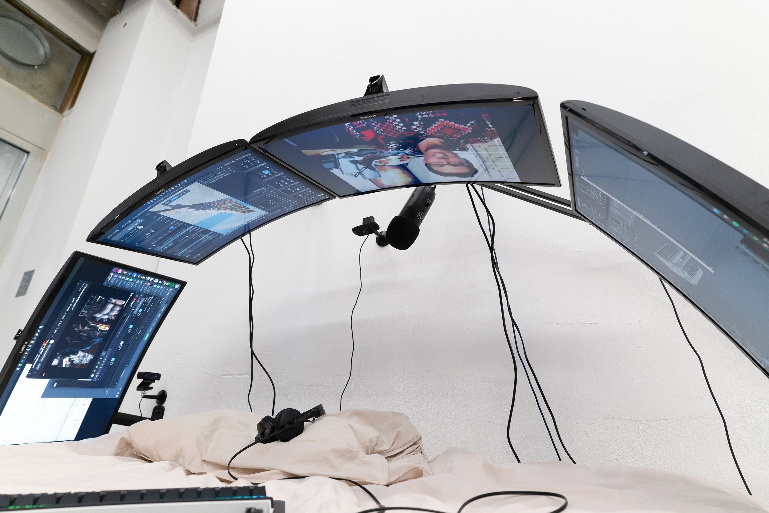  Filip Kostic,  Bed PC 2 , Custom built water cooled computer built into the frame of the bed. Variable screens to create a shield like shape, blanket, and pillows. Variable peripherals including keyboard, mouse, streaming microphone, and cameras for