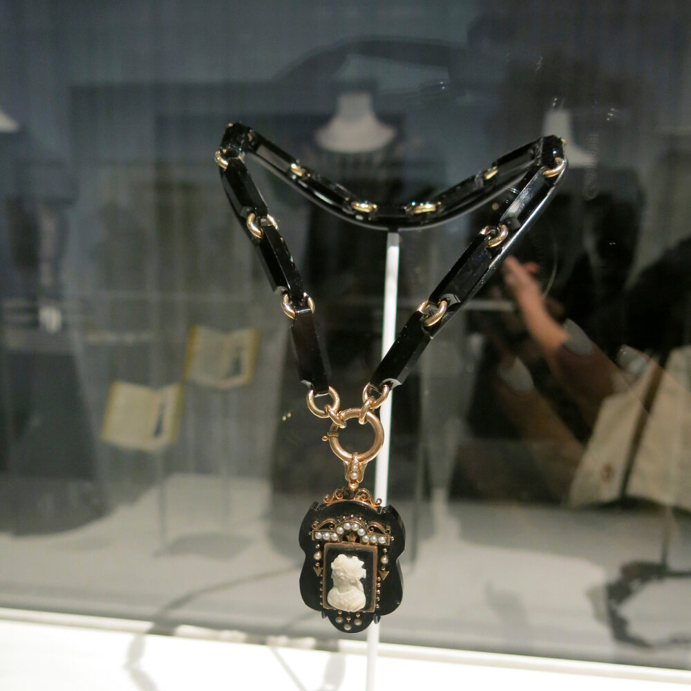 Late 19th century mourning necklace and locket of gold, onyx and seed pearl with hair.jpg