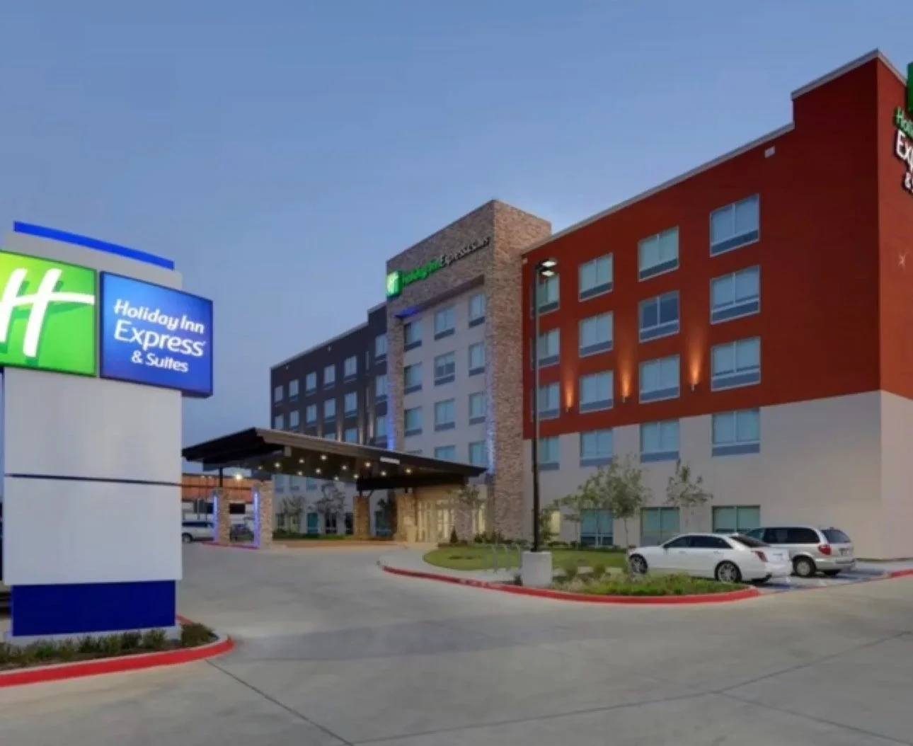Image shows Holiday Inn Express Hotel from street view.