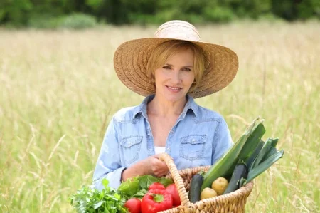 photodune-1550907-woman-in-straw-hat-with-basket-of-vegetables-walking-through-a-field-xs.jpg