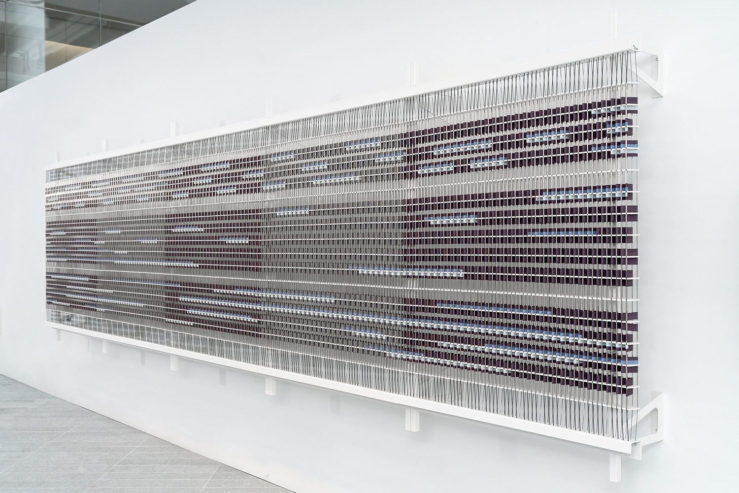  The length of the artwork represents the 5-hour extract. 5 alternating sections of broad Violet and Grey ribbons running across the frame further divide the artwork into hours along the horizontal axis.  Installation view  Louvre Abu Dhabi  Image co