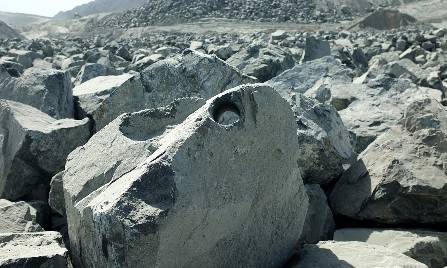    Boulder Plot,   2014  Giant boulders with drill holes are hand picked from quarries. These holes result from the violent rock blasting process. Post the exhibit the boulders are returned to enter into the construction market. 