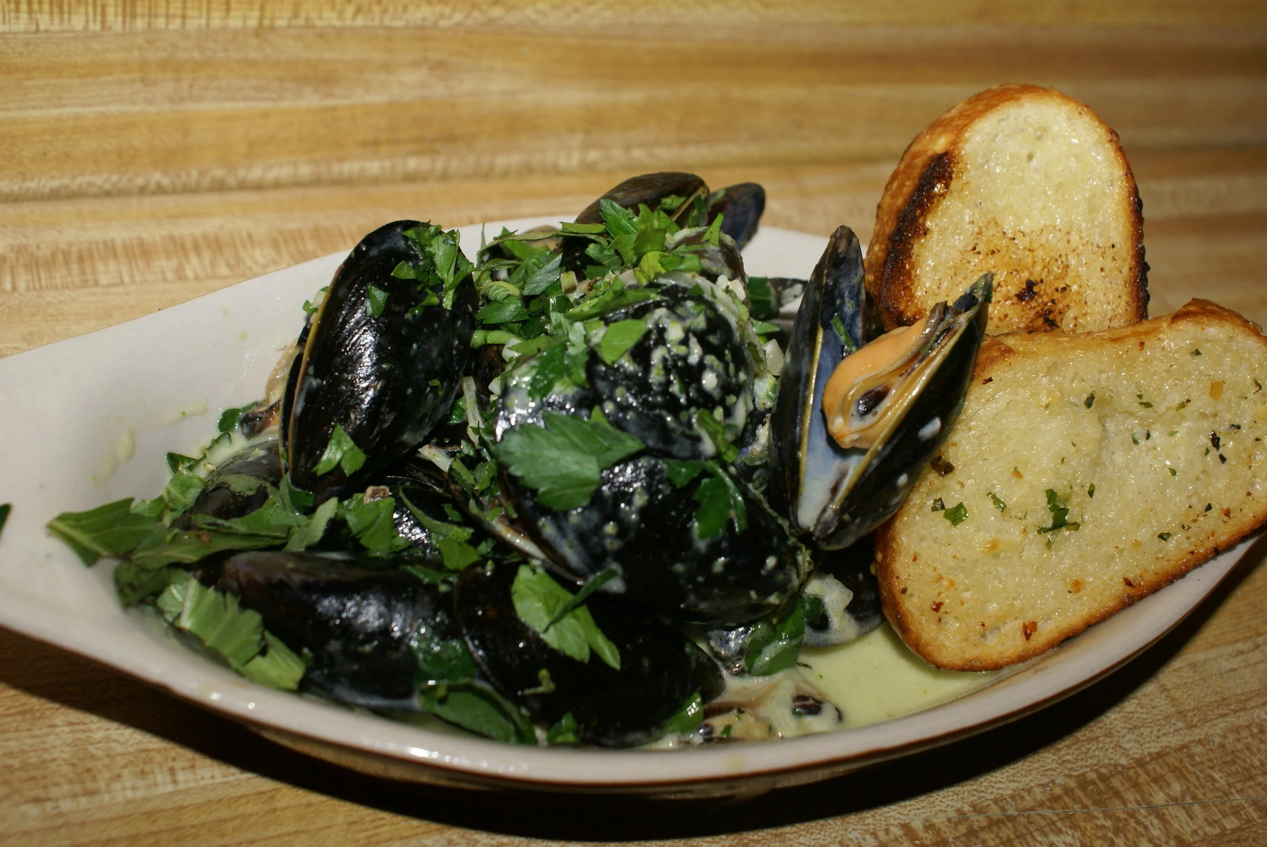 Matteo's Mussels - try them with pancetta! pesto, cream, garlic, shallots, served with crostini
