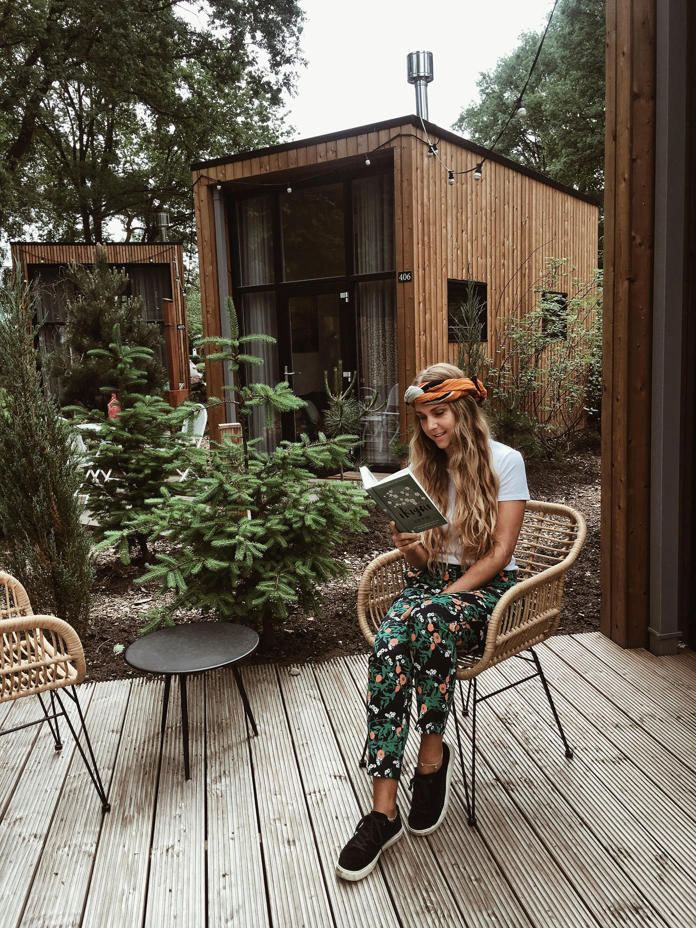 Sustainable outfit and a tiny house . Gabriëlle wears pants from Sophie Stone , a Goat Organic Apparel shirt, and Toms shoes.