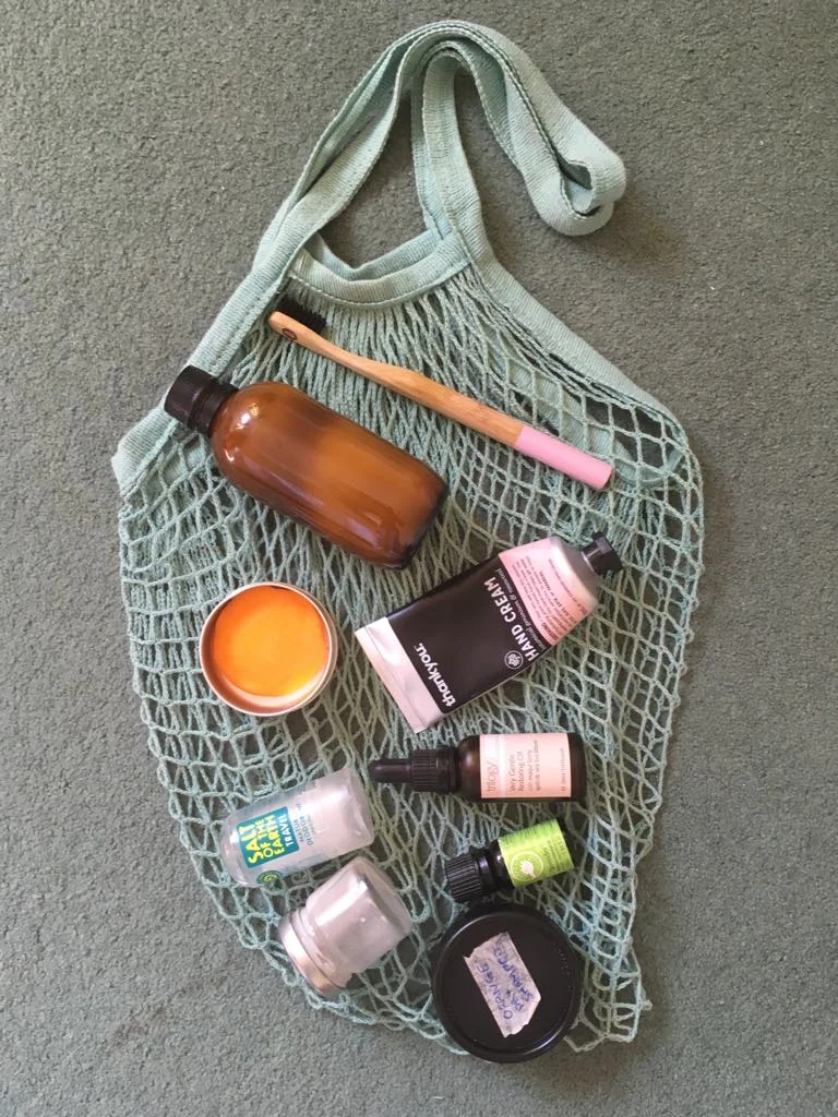 Net bag I use for groceries, as well as as a beach bag. Homemade single use plastic swaps - toothpaste, perfume, dry shampoo, bronzer. Since this photo I've also added deoderant to the mix too!