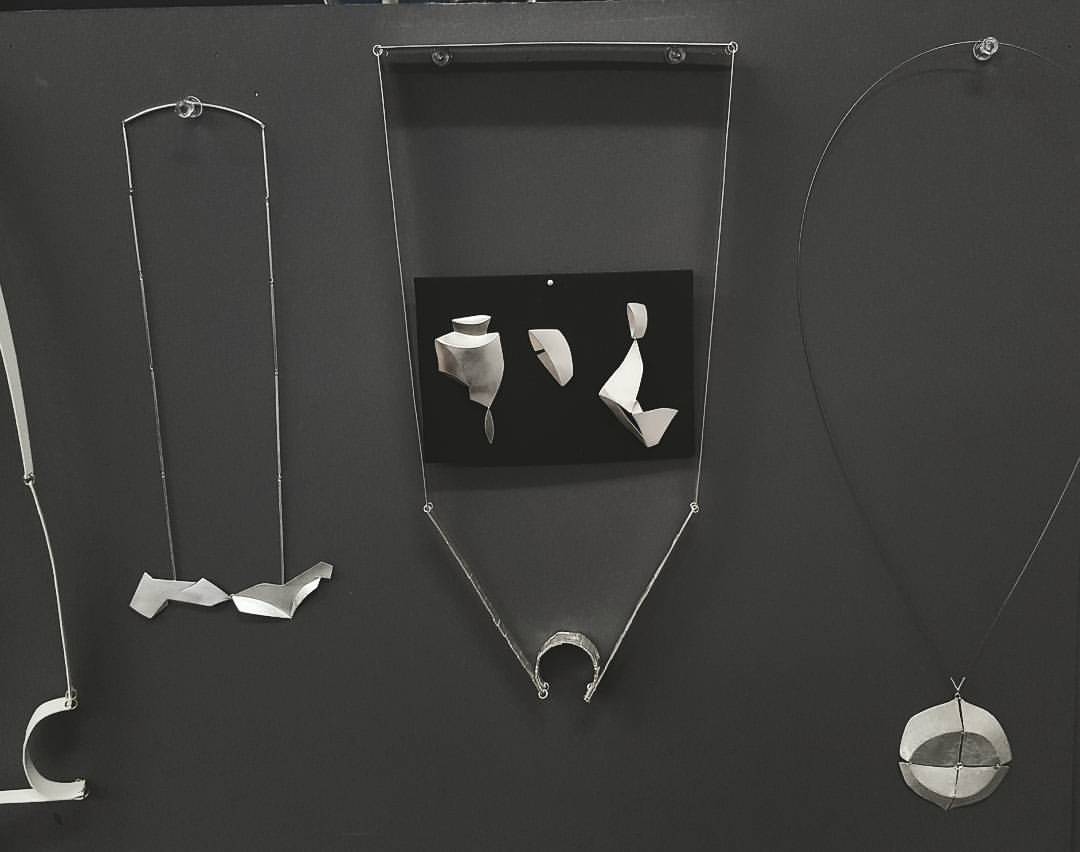   Assortment of silver jewelry  [left to right: pendant, necklace, asymmetrical earring triplet, pendant]  sterling silver 