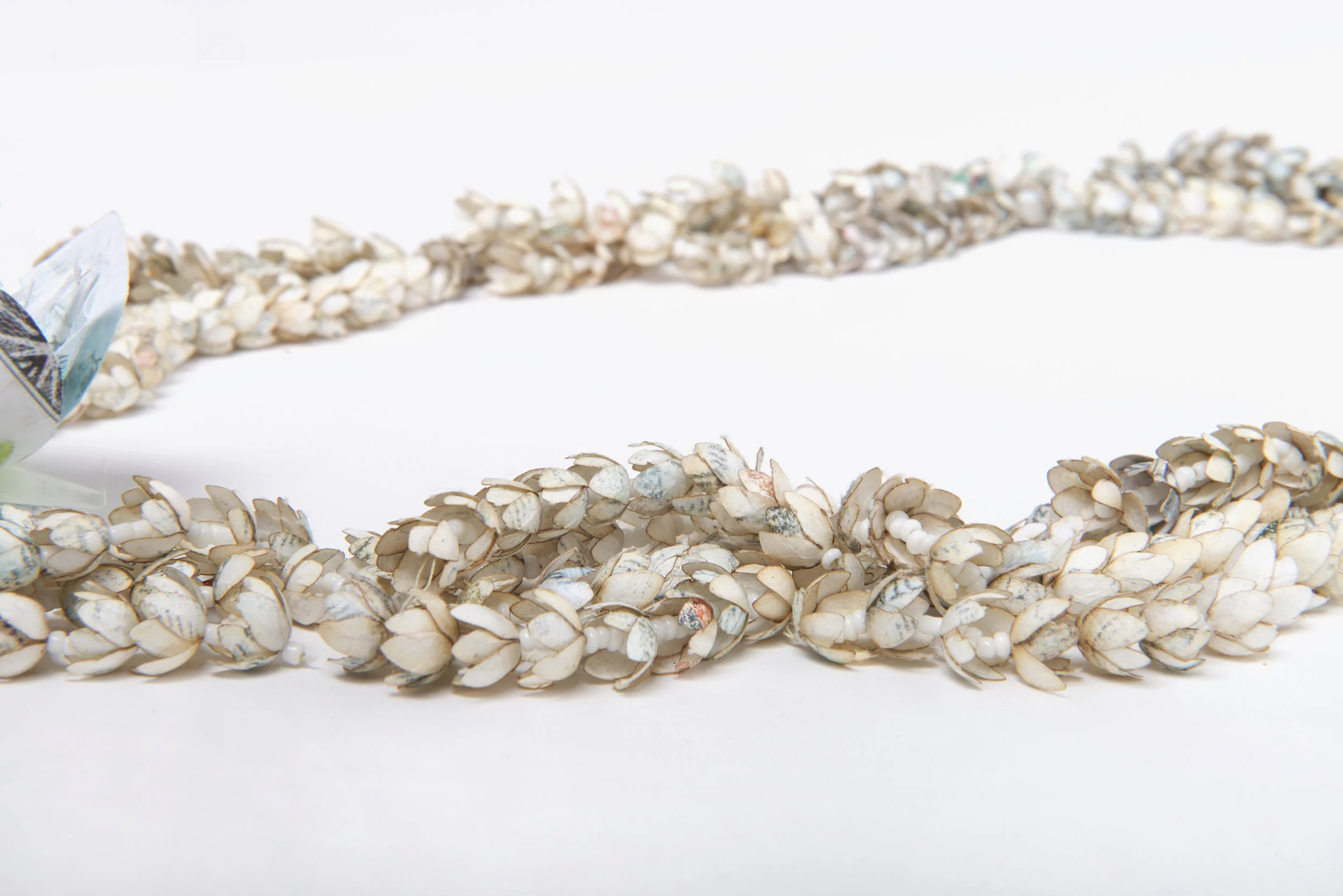 (Culture) Orphan (detail) 14”x8”x3” Duplicates of my American Citizenship papers, cotton thread, glass beads