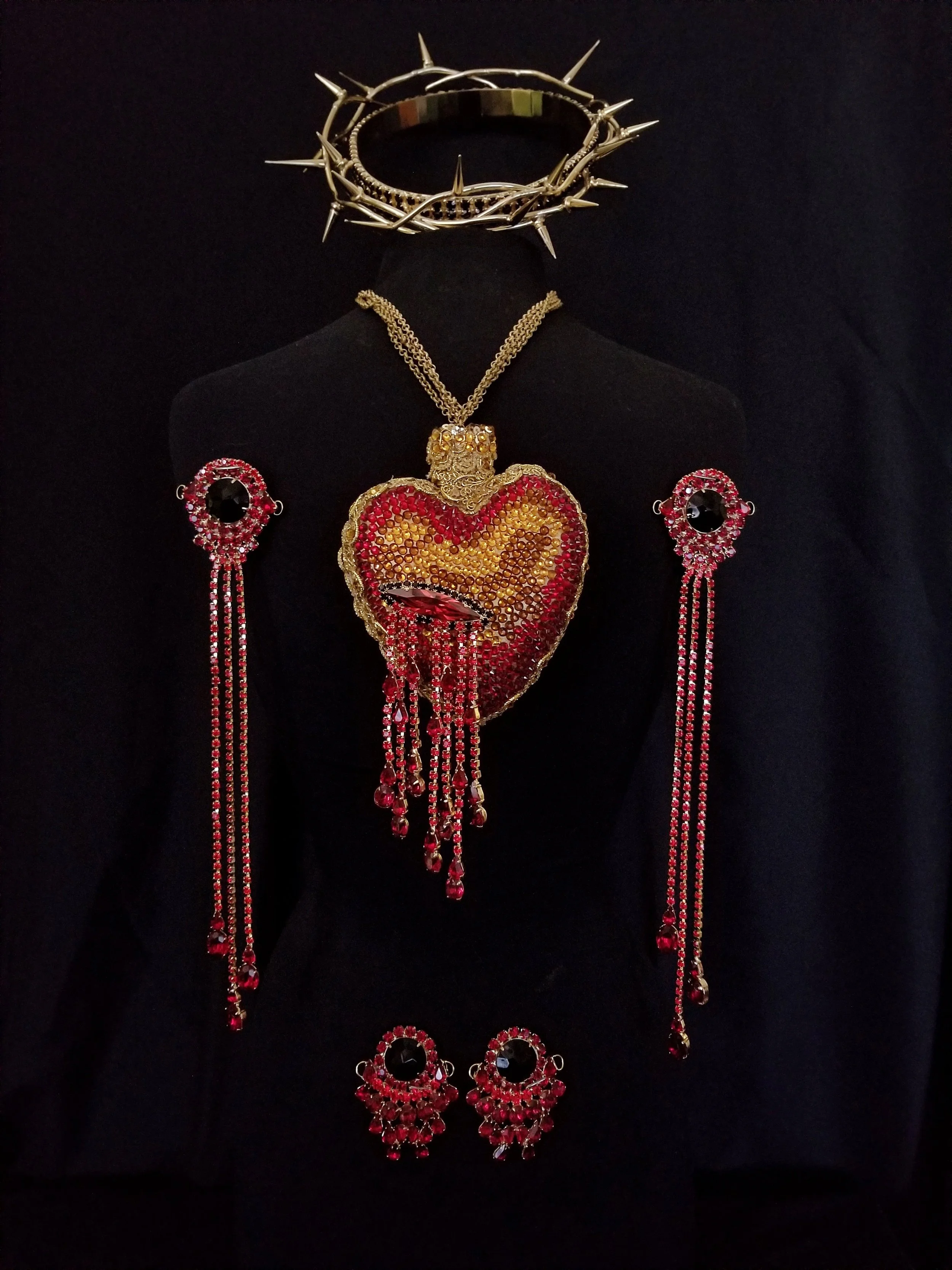 ☆ PASSION REGALIA ☆ Bespoke Sacred Heart pendant, palm stigmata with blood drop fringe, feet stigmata, and black diamond crown of thorns. Light Siam, Siam, Garnet, and black diamond Swarovski and Preciosa crystal with gold trim and 24k gold plate.