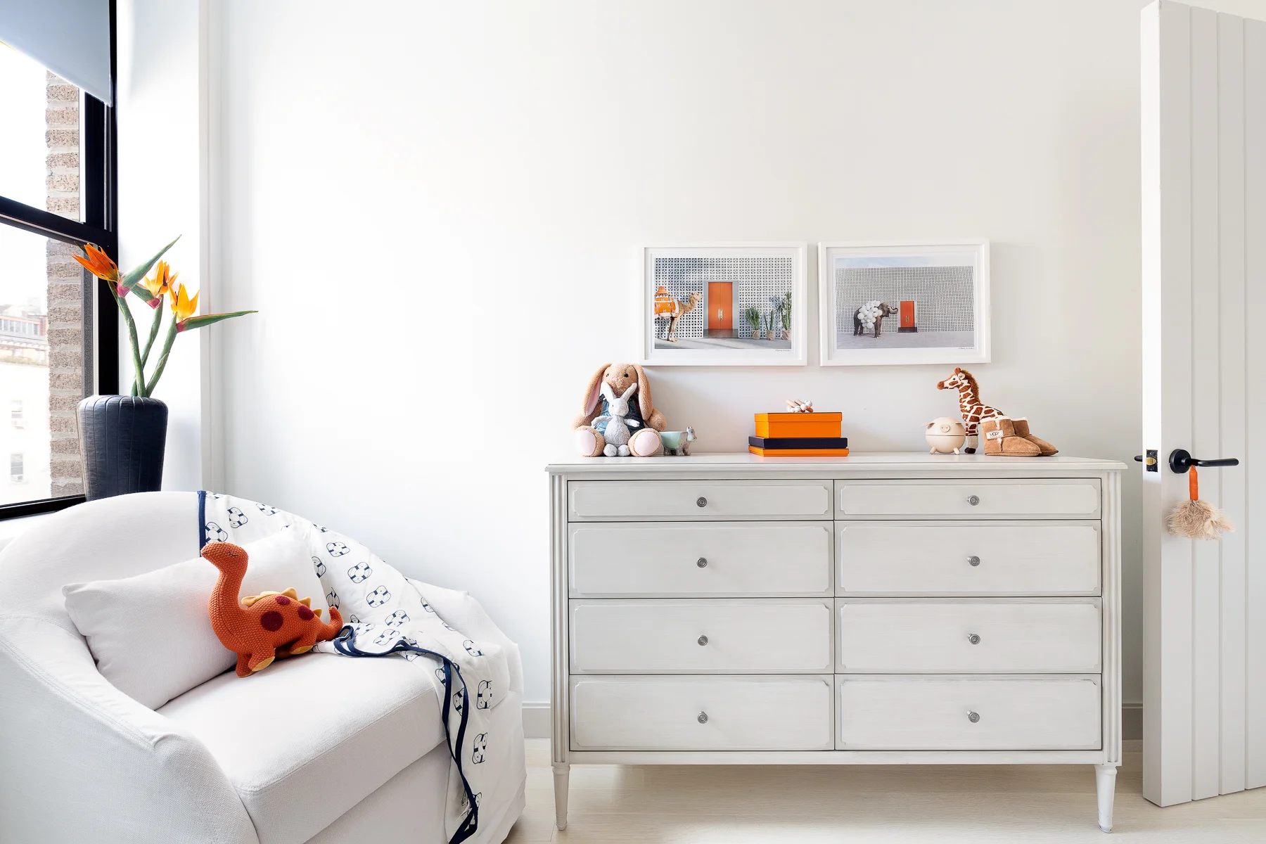 Orange is the new black, bringing in the pop of color on the functional side of the room. While the parents change and read to the little one, I brought in Hermes orange to create a luxe sophistication to the room. The overall neutral backdrop comes to life with this accent color.