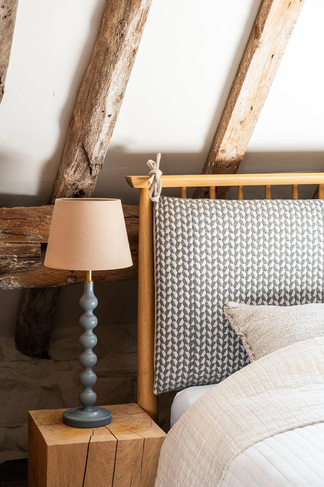 bedroom luxury interior design hereford with wooden bespoke headboards featuring headboard cushions, solid wood beside table, luxury bedding and bedroom lighting inspiration, modern lamp and wooden beams