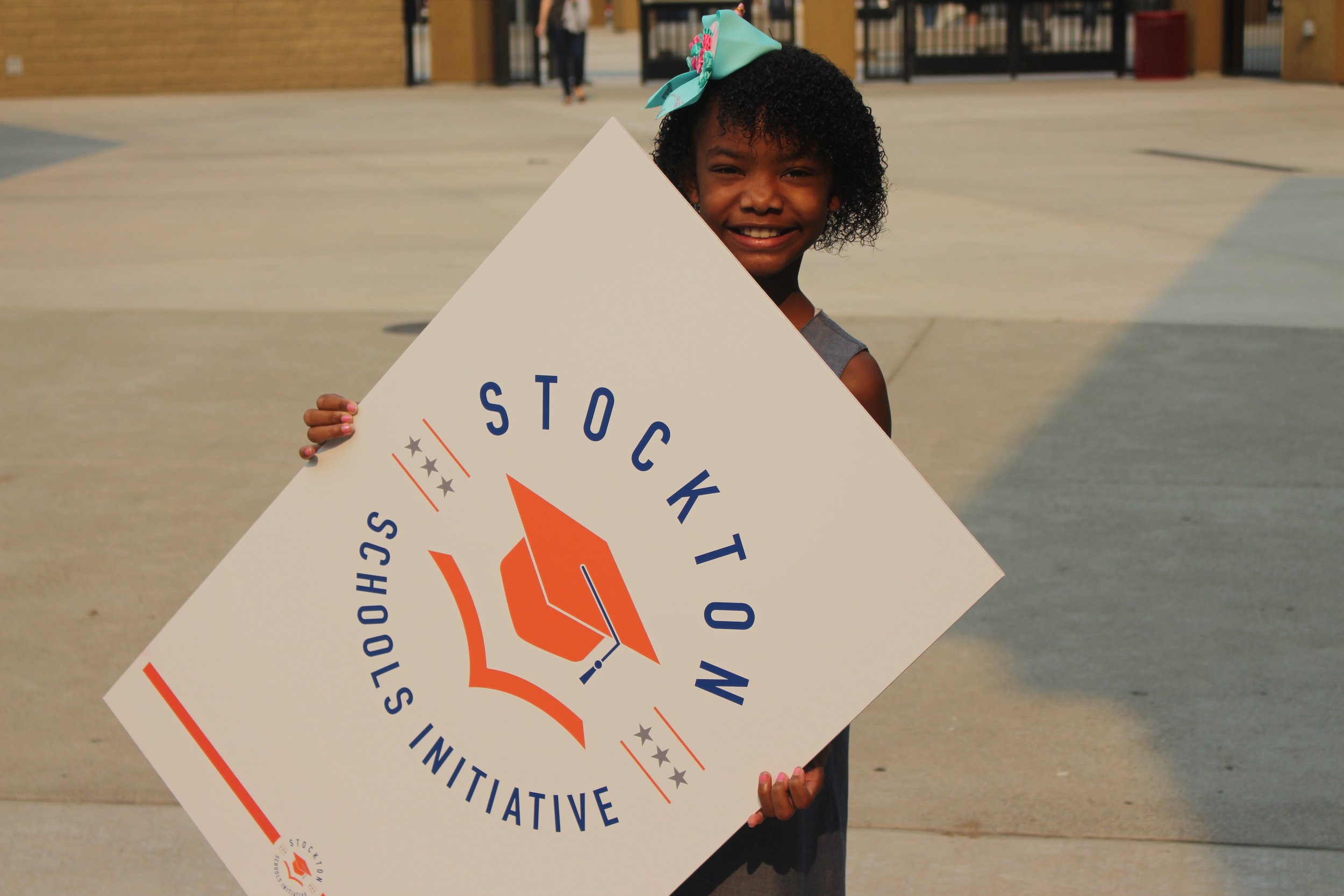 child with Stkn Sch Initiative logo.jpg