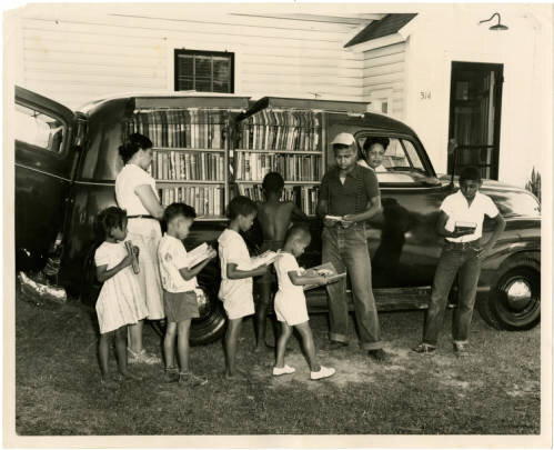 Photograph from Northampton County, North Carolina titled _African-American children line up outside of Albemarle Region bookmobile._  Courtesy of the North Carolina Digital Collections.jpg