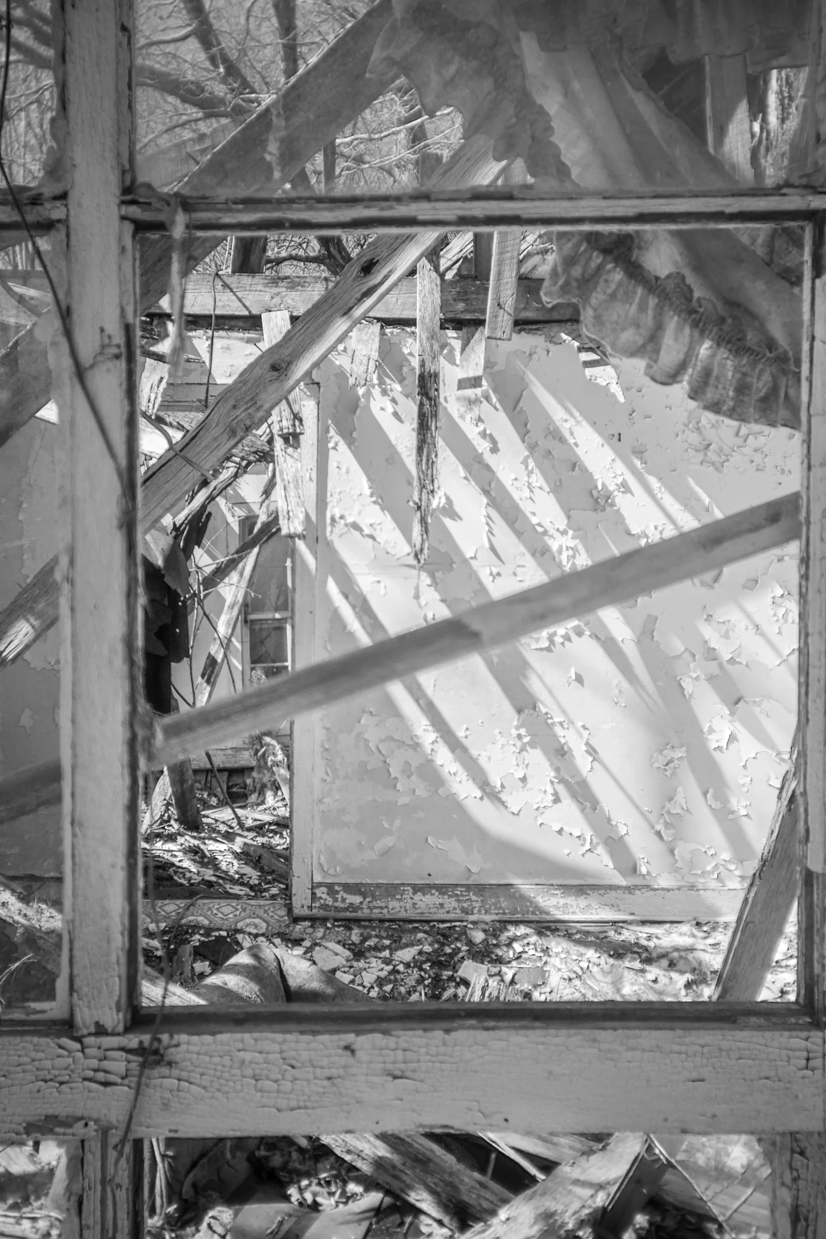 Light falling through a collapsed wall inside an abandoned house near Bowker Road, Tennessee, black and white photograph from My Tennessee by Adam CK Vollick