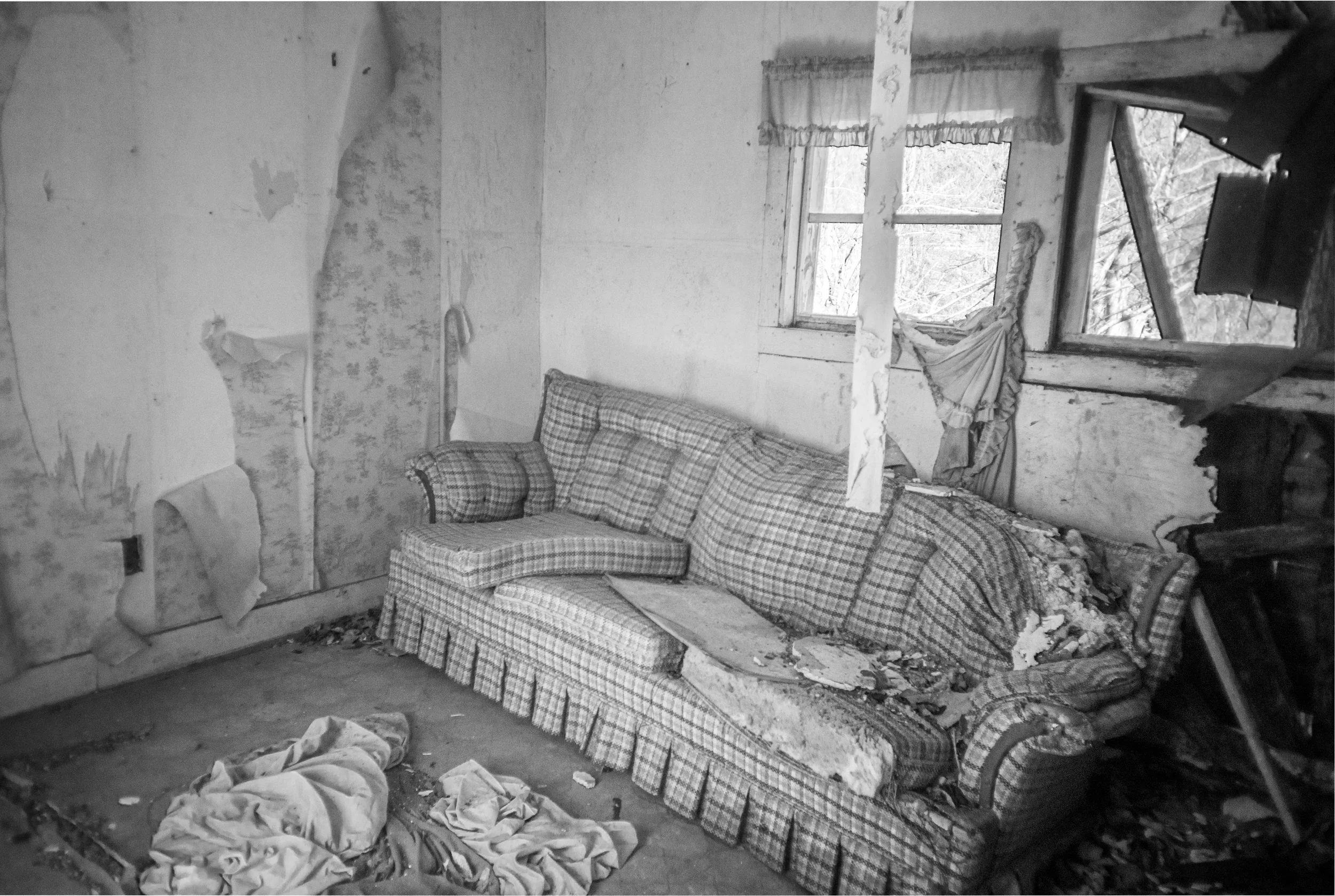 Plaid couch in an abandoned living room near Bowker Road, Tennessee, black and white photograph from My Tennessee by Adam CK Vollick