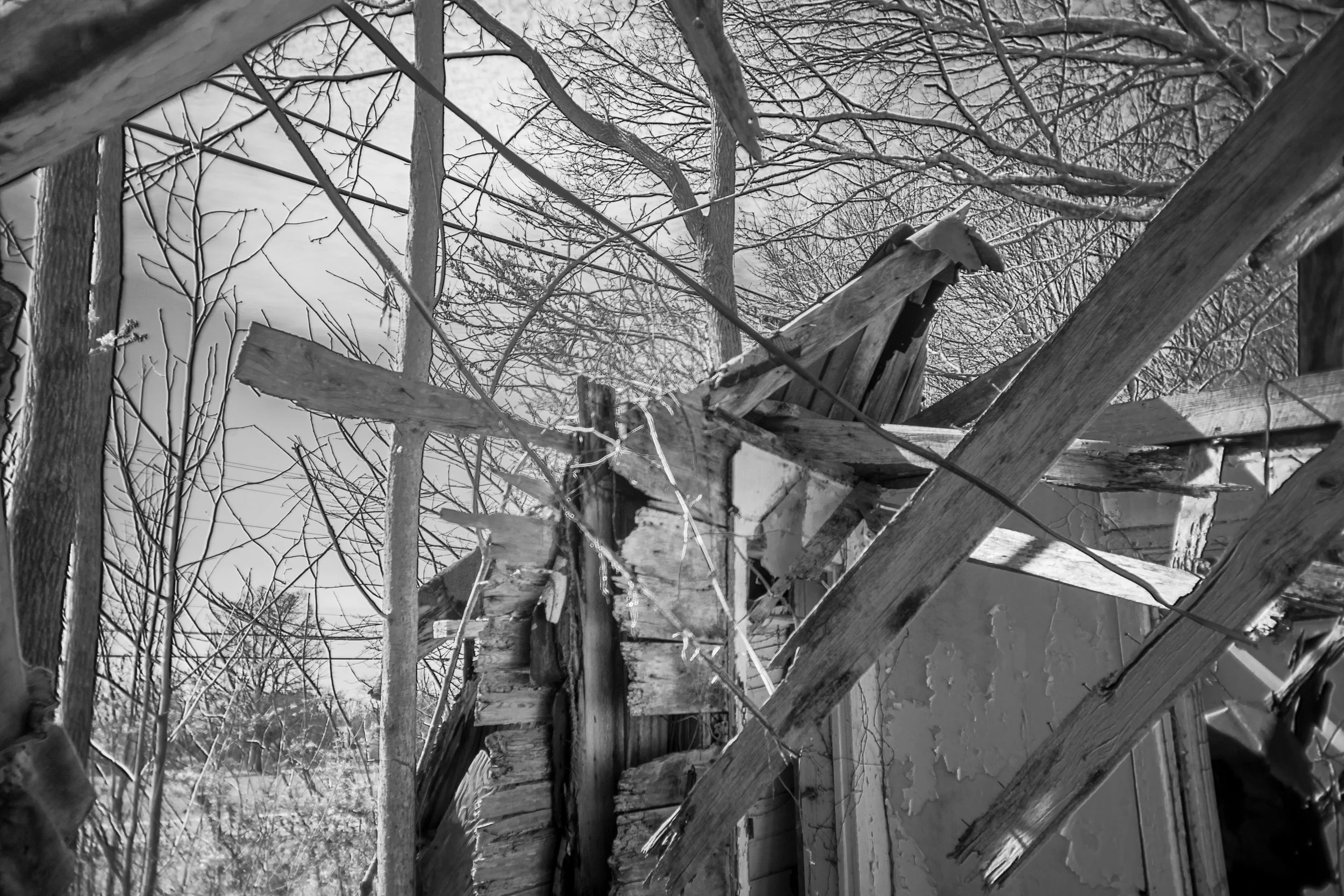 Broken rafters against the sky in an abandoned house near Bowker Road, Tennessee, black and white photograph from My Tennessee by Adam CK Vollick