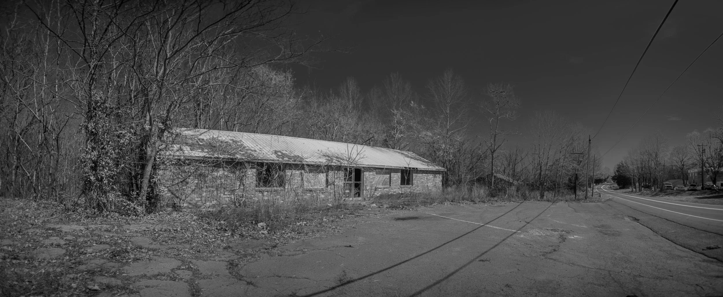 Long, low abandoned building beside a rural road near Bowker Road, Tennessee, black and white photograph from My Tennessee by Adam CK Vollick