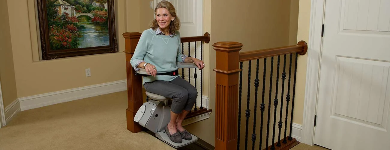 Bruno-Elan-stairlift-lady-riding-top-of-stairs.jpg