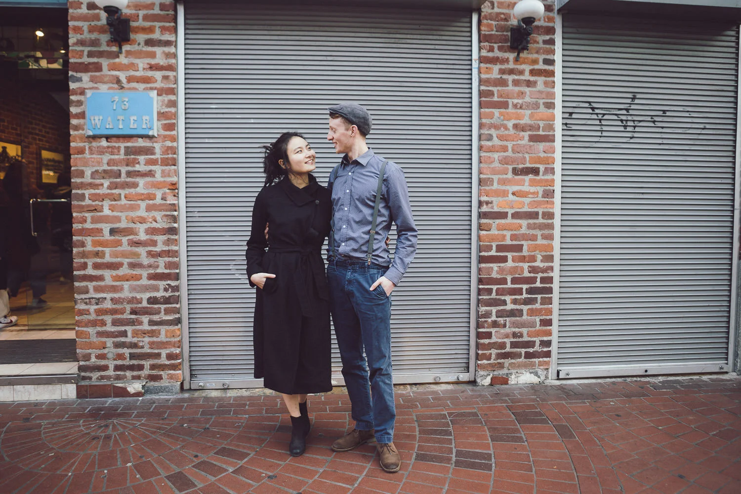 Angel and Tim stand for an engagement photo in Vancouver, BC