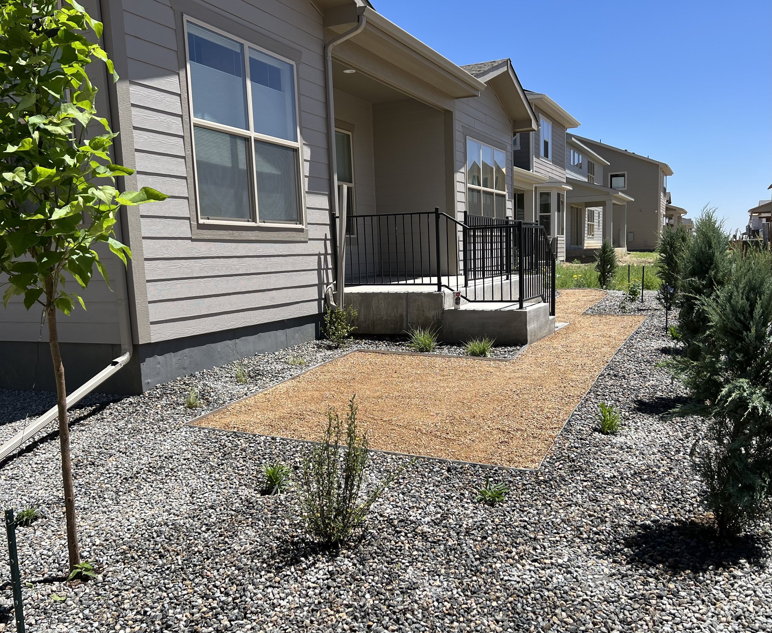 Backyard Xeriscape with grey rock and tan decomposed granite