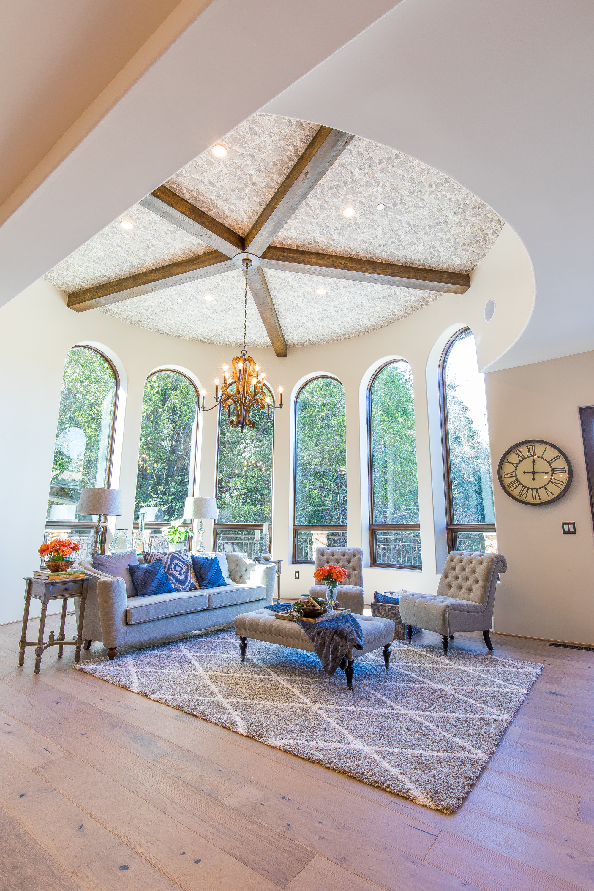  The 14 foot ceiling features hand-distressed and hand-stained exposed beams from which a glorious 12 light candle style renaissance chandelier extends 