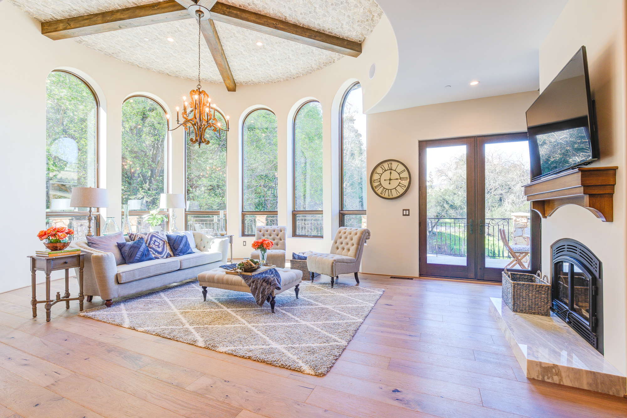  Six majestic 11 foot tall arched windows cast cheerful daylight into the enormous family room 