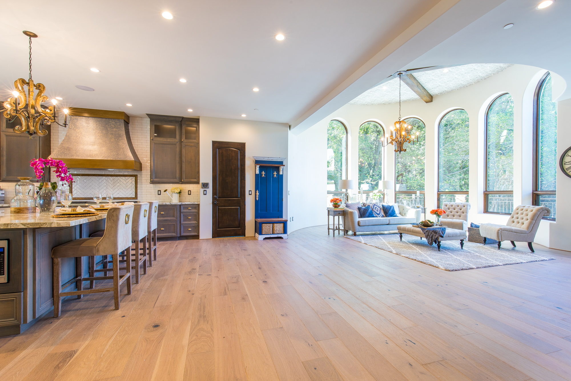  European white oak hardwood floors provide the foundation for the custom made floor to ceiling hand-stained cabinetry that flank the wood burning fireplace, topped with a hand-stained wood mantle 