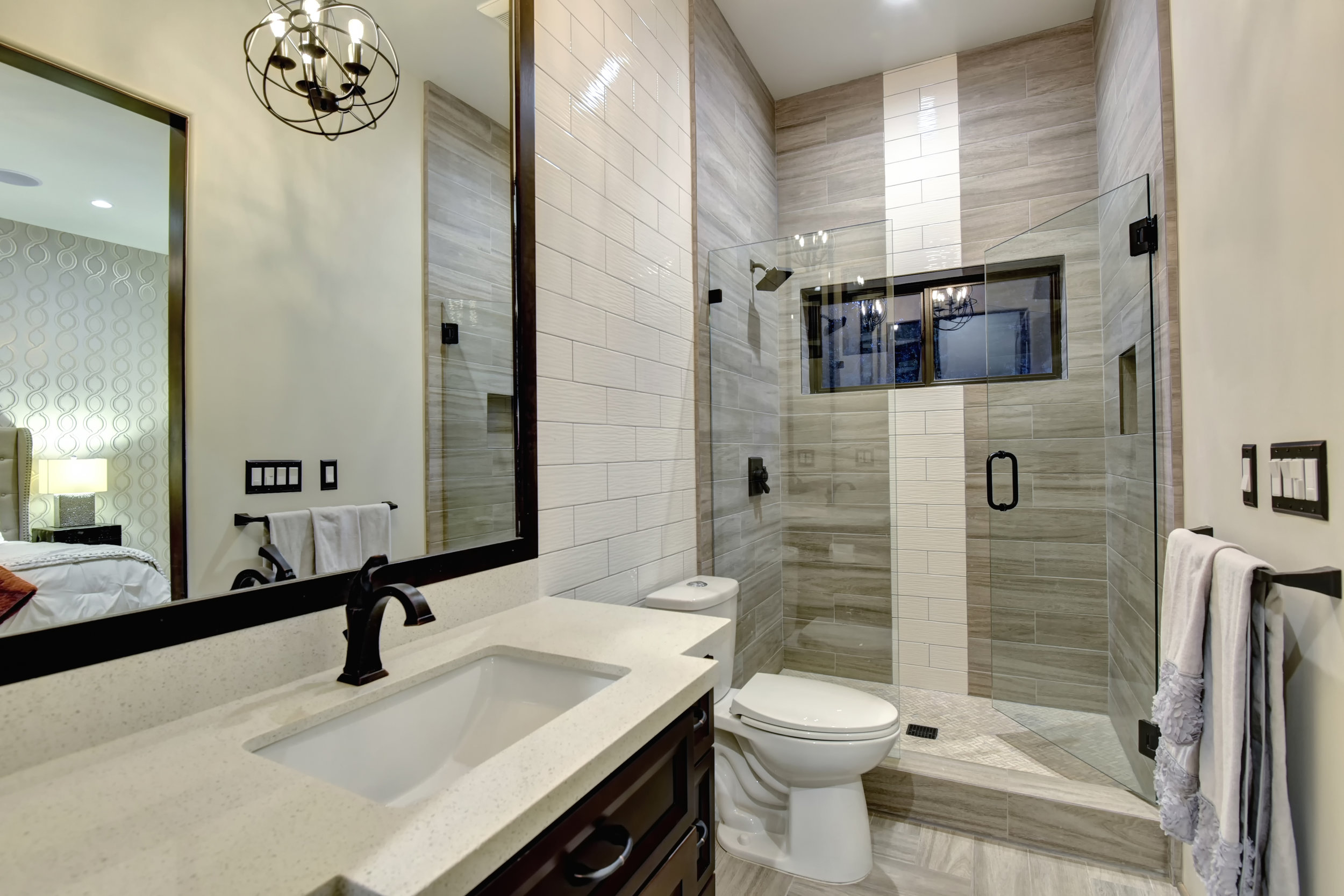  All of the bathrooms have custom vanities, quartz stone counters, and tile showers 
