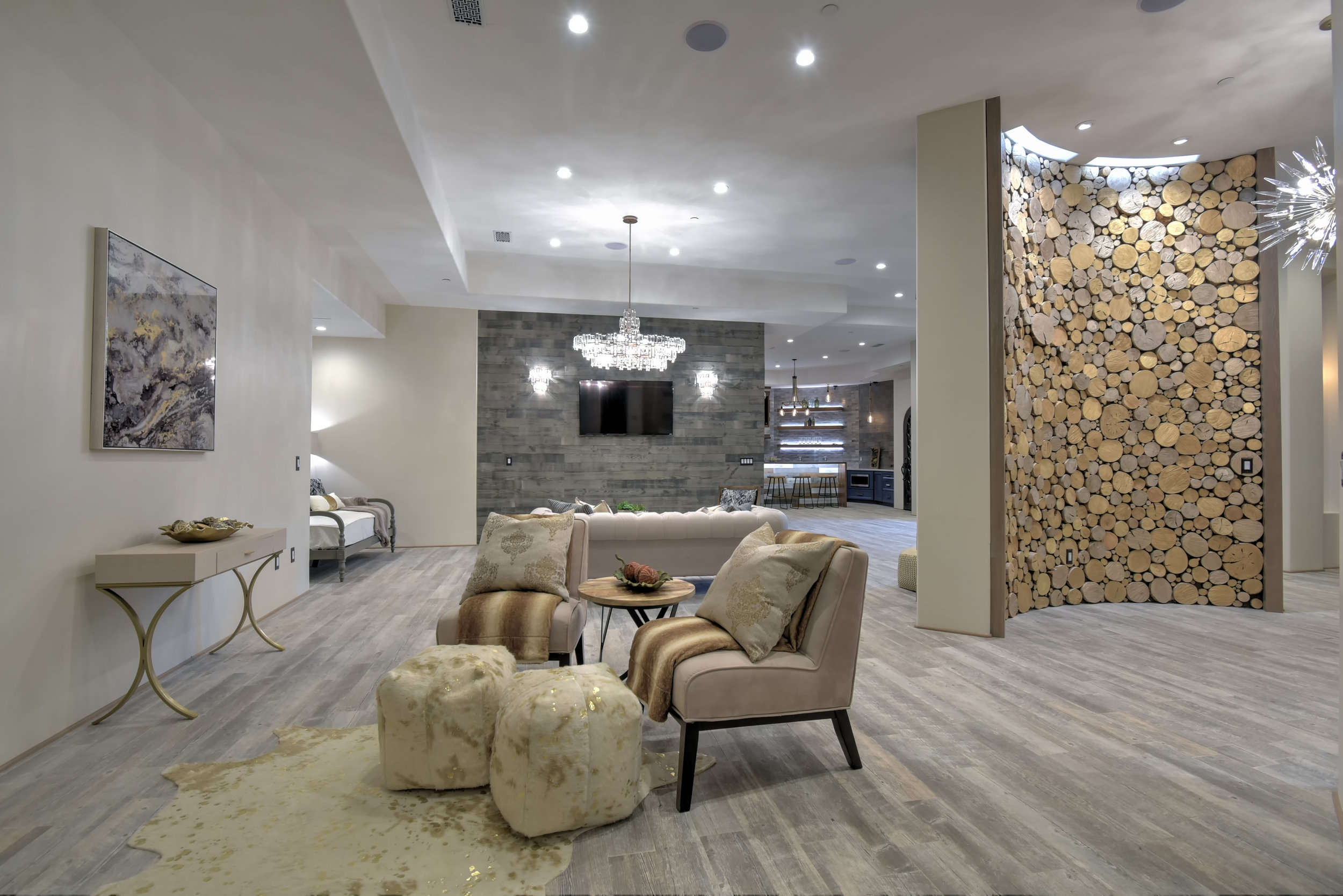  At the foot of the custom made iron staircase leading down to the lower level, Eucalyptus trees cleared from the Estate have found a new home as a breathtaking art installation on 2 beautifully curved walls. The gold and silver highlights of these w