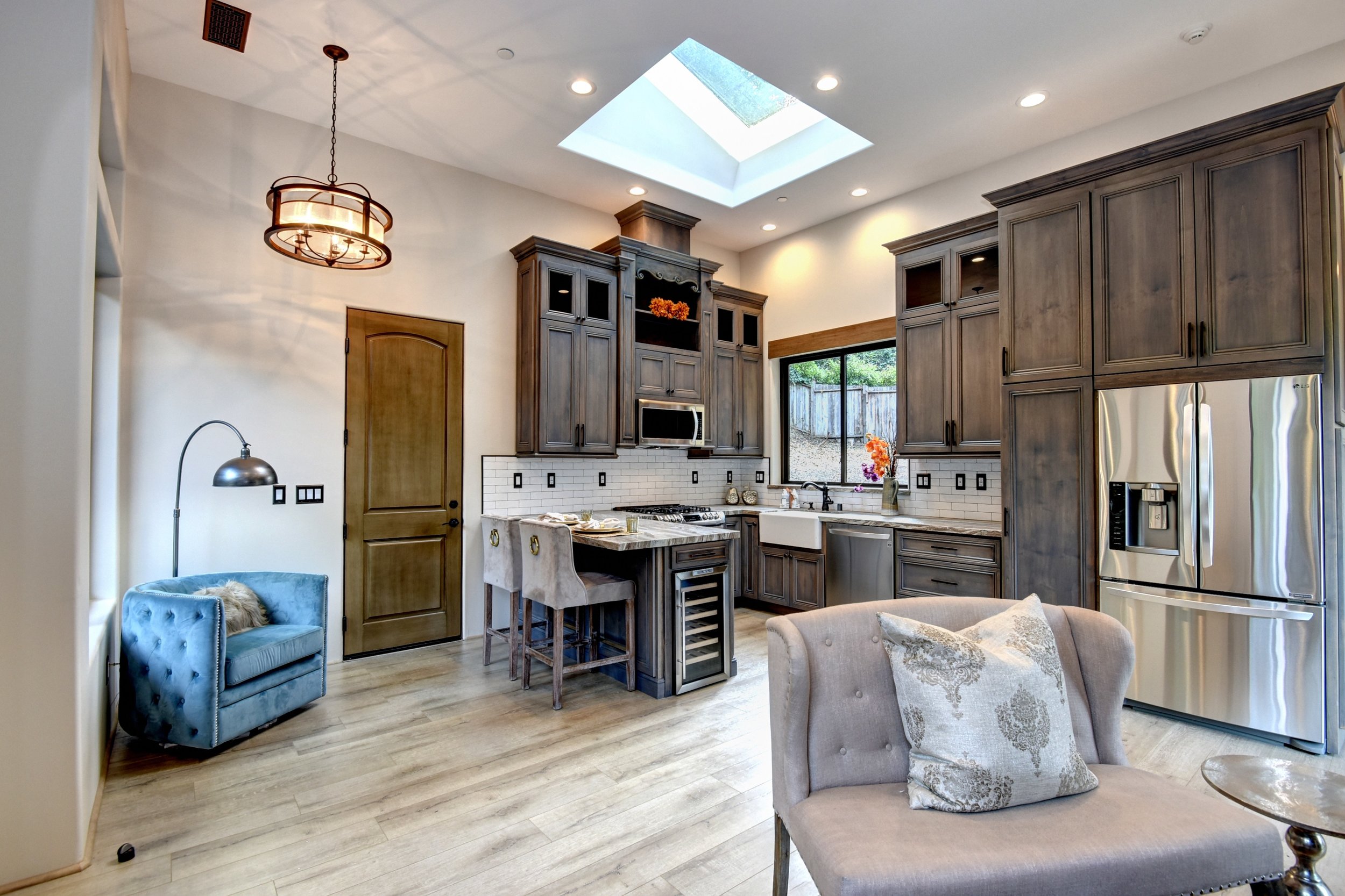  The kitchen in the guest house boasts beautiful hand-stained alder custom cabinetry, two lazy susan cabinets, a pull out pantry, a breakfast bar, and state of the art stainless steel appliances, including a gas range, dishwasher, microwave, refriger