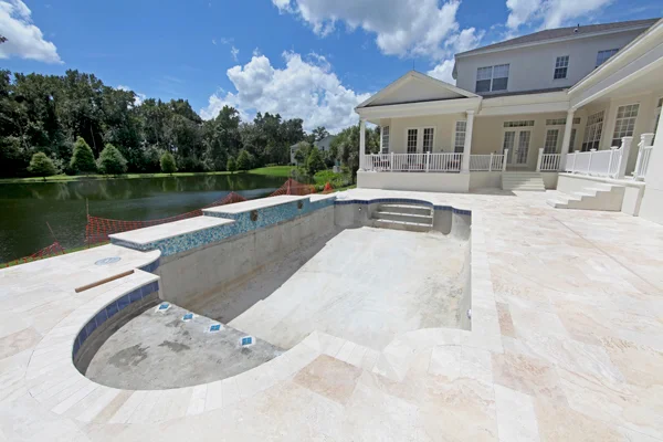 A luxurious house with an outdoor pool facing the lake