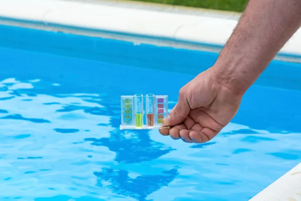 A Swimming Pool Expert Testing Pool Water