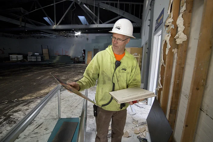  LOI employee Jeff Wagner browses through a pile of old records left behind before the start of demolition. 