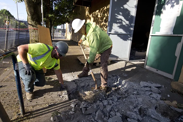  Kyle Berens, left, and Jeff Wagner dig for access to the property’s water line. 
